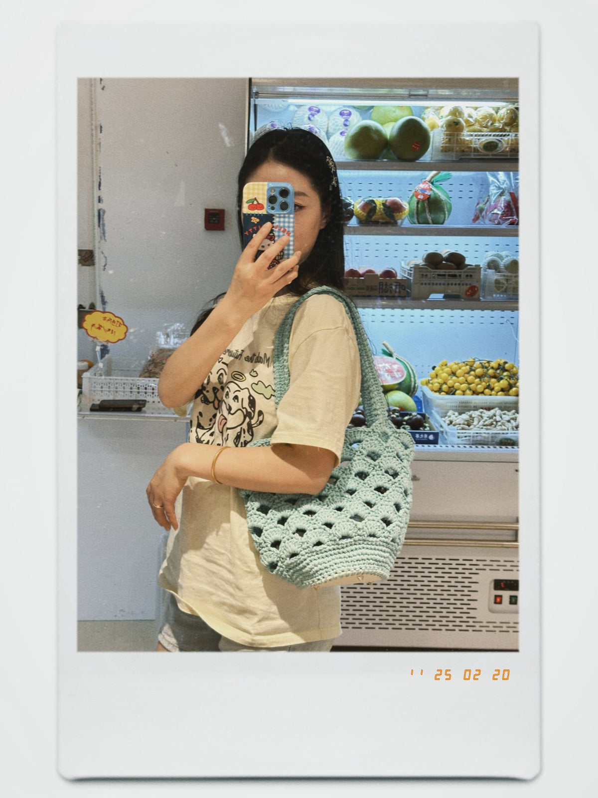 Real customer mirror selfie with a sage green crochet shoulder bag